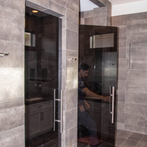 A Cutting Edge Glass & Mirror Custom Grey Glass Bathroom Door Installation